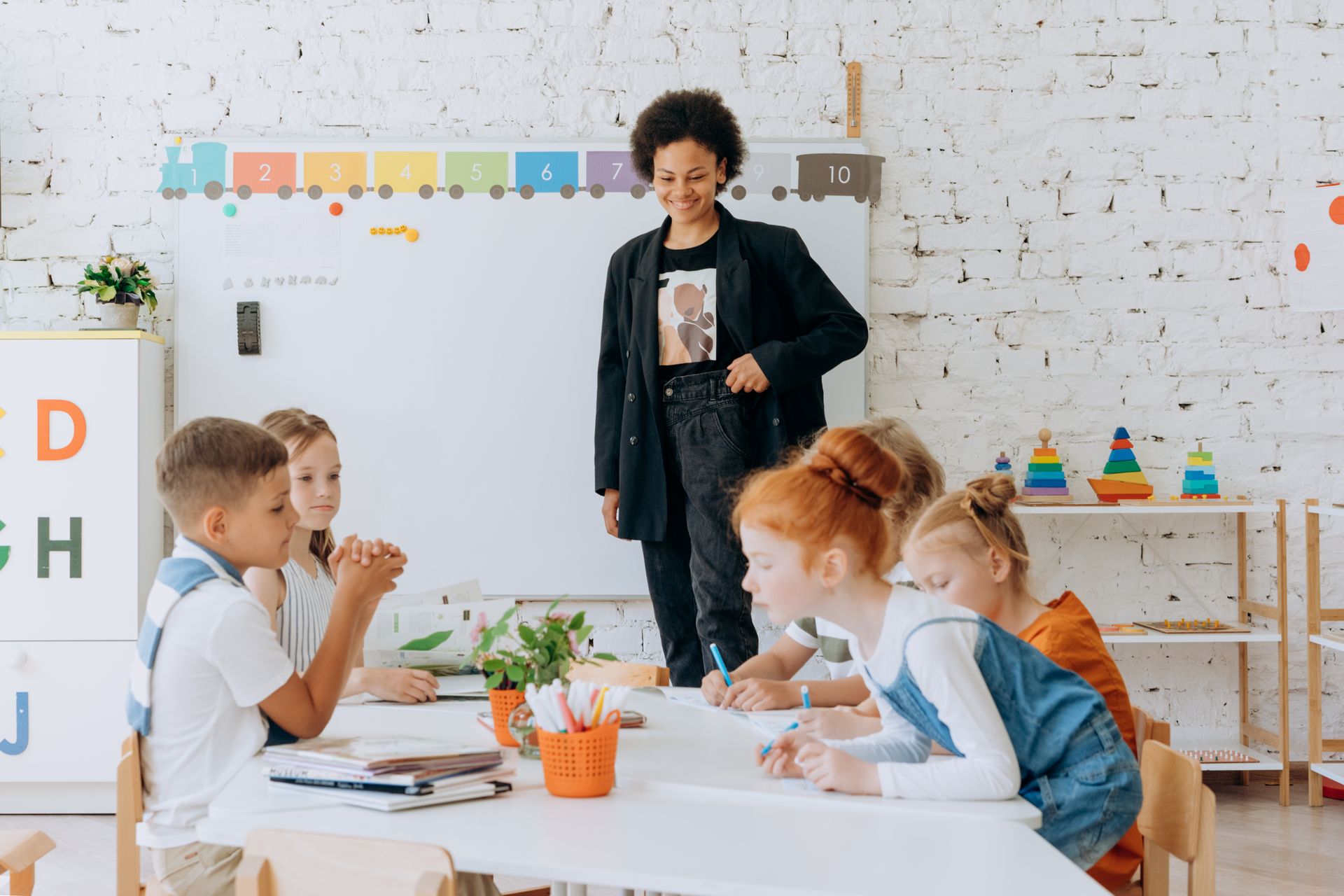 A child working on a hands-on classroom activity in bright, warm light