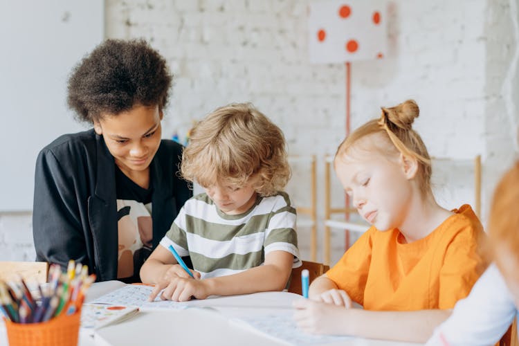 Woman Looking At The Kids Writing