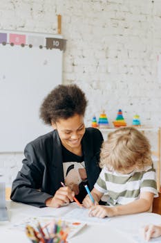 A teacher and a child engaging in a learning activity in a bright, colorful classroom.