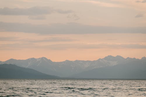 Photo of Mountains and Body of Water