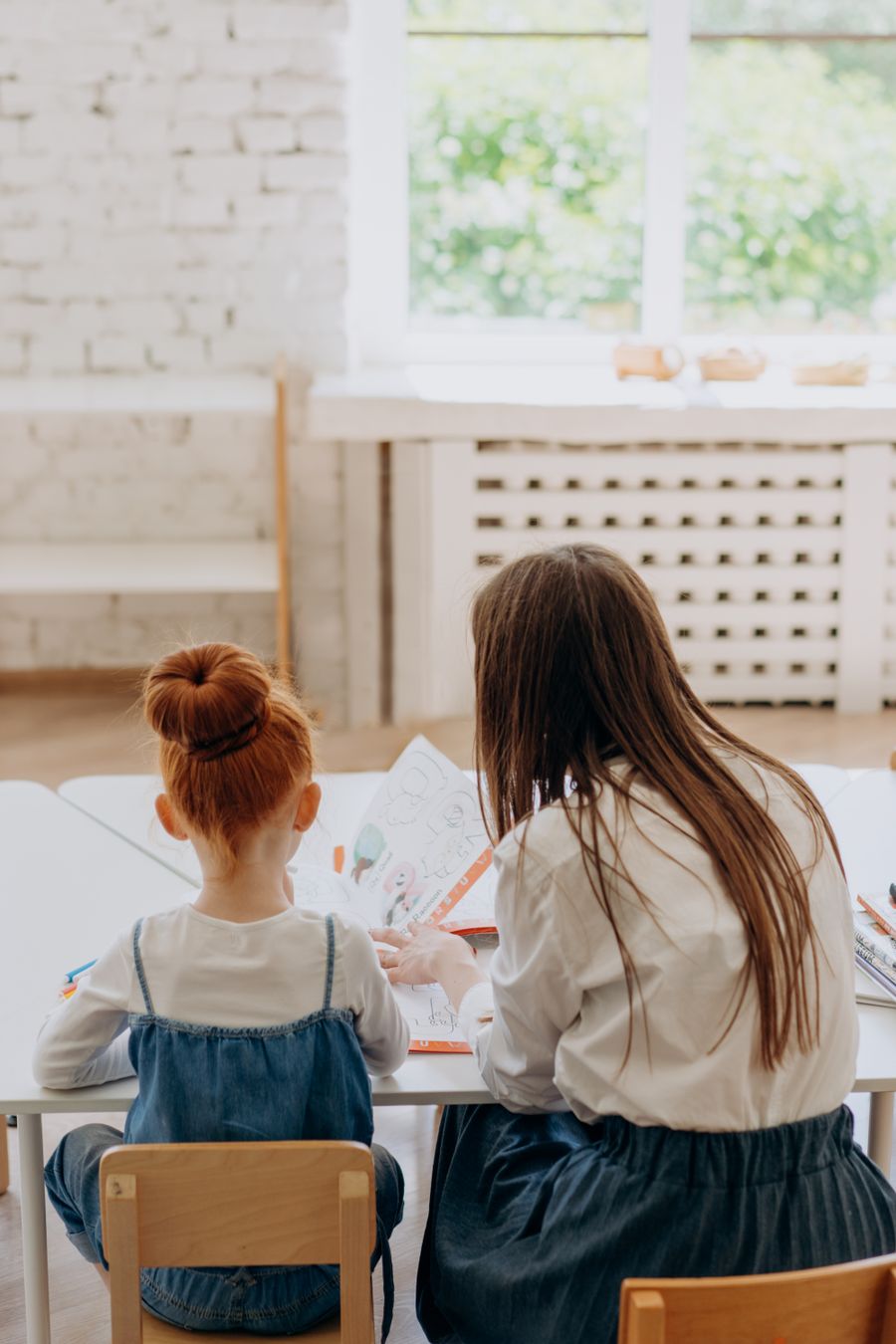 Placeholder image of a teacher and child working together — replace with a photo of Nicole