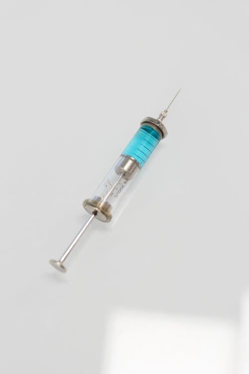 Free Silver Syringe on White Surface Stock Photo