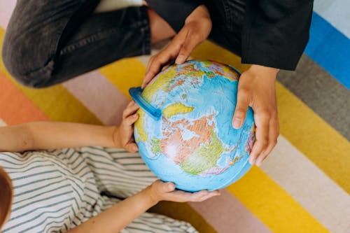 A Person Holding a Globe