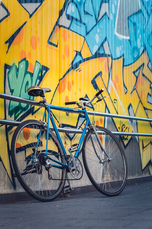 Blue Bicycle Leaning on Railing · Free Stock Photo