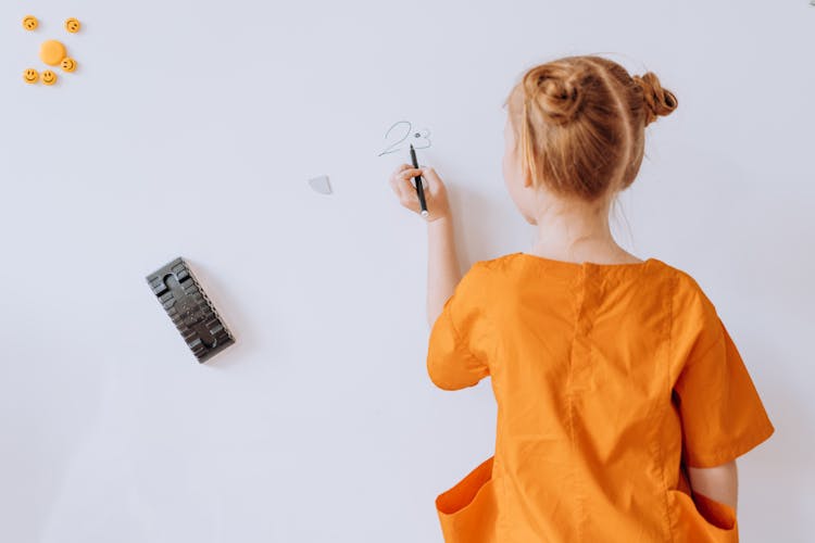 Back View Of A Girl Writing On The Whiteboard