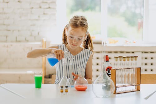 A Girl Holding a Flask with Colored Liquid