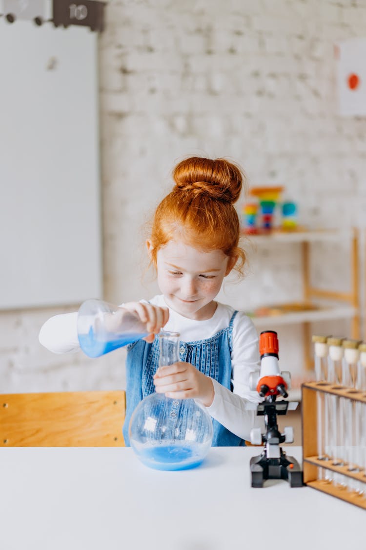 A Girl Doing A Science Experiment