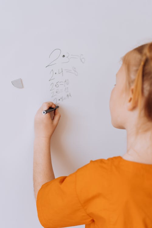 A Child Writing on a White Board