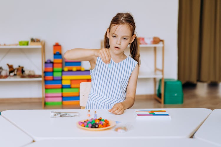 A Girl Playing In The Table