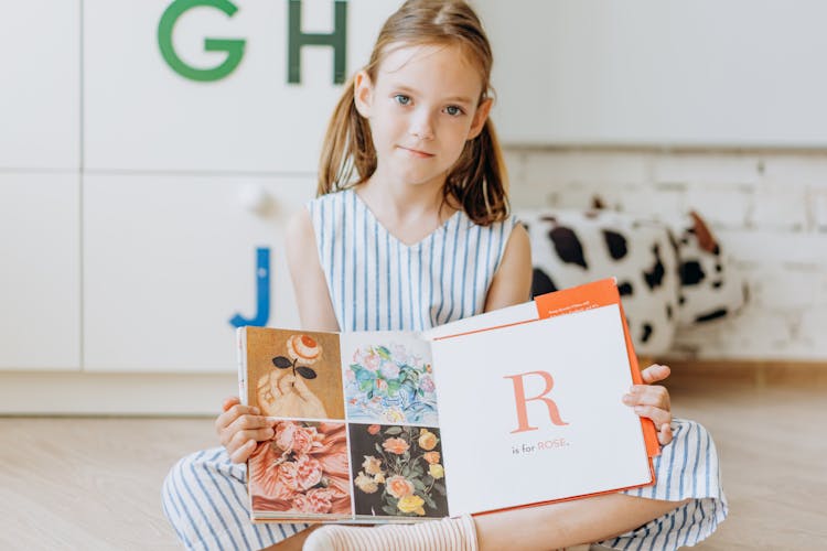 A Girl Holding A Book