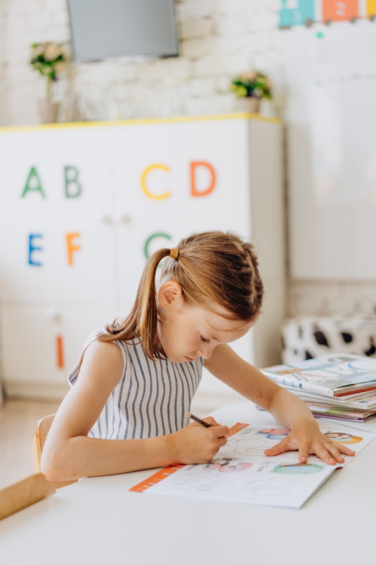 A Girl Coloring A Book