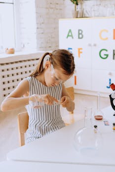 A girl in a classroom experimenting with lab equipment, inspiring curiosity and education.