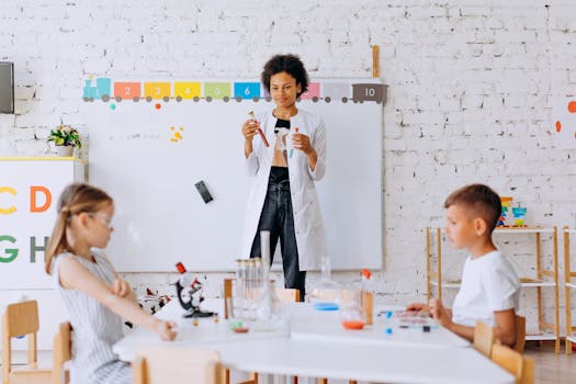 Children conduct a science experiment under teacher's guidance in a classroom setting.