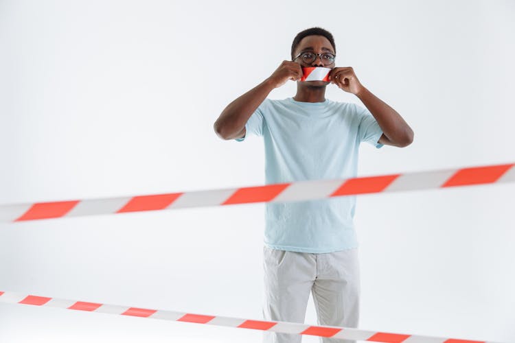 Man Standing Near The Barricade Tape