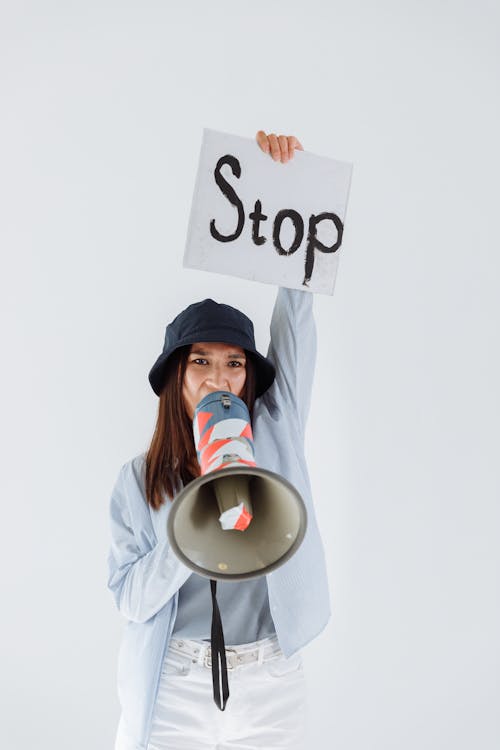A Woman Protesting while Holding a Megaphone