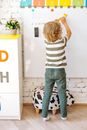 A Kid Sticking Yellow Smiley on the Whiteboard