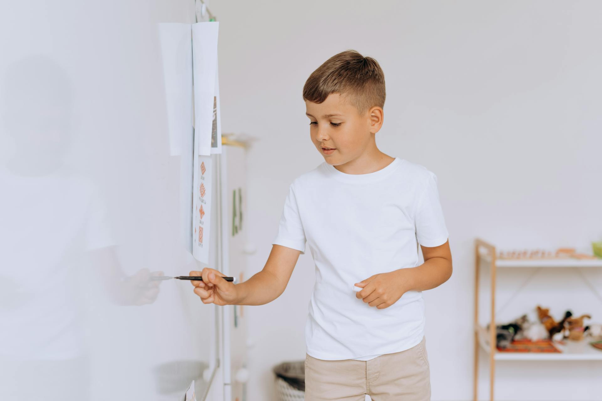 Boy Writing on a Whiteboard