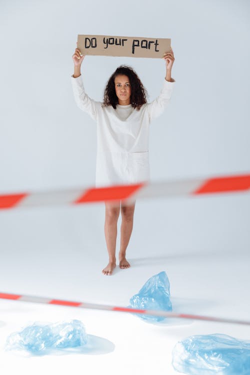 Woman Holding a Sign on Cardboard