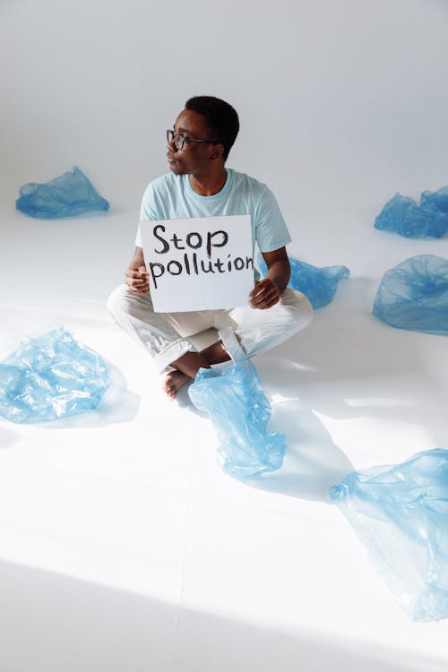 Man Holding a Stop Pollution Sign 