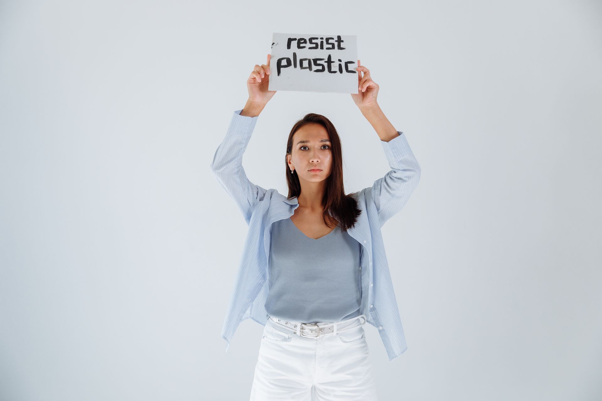 Woman with Arms Raised Holding a Sign