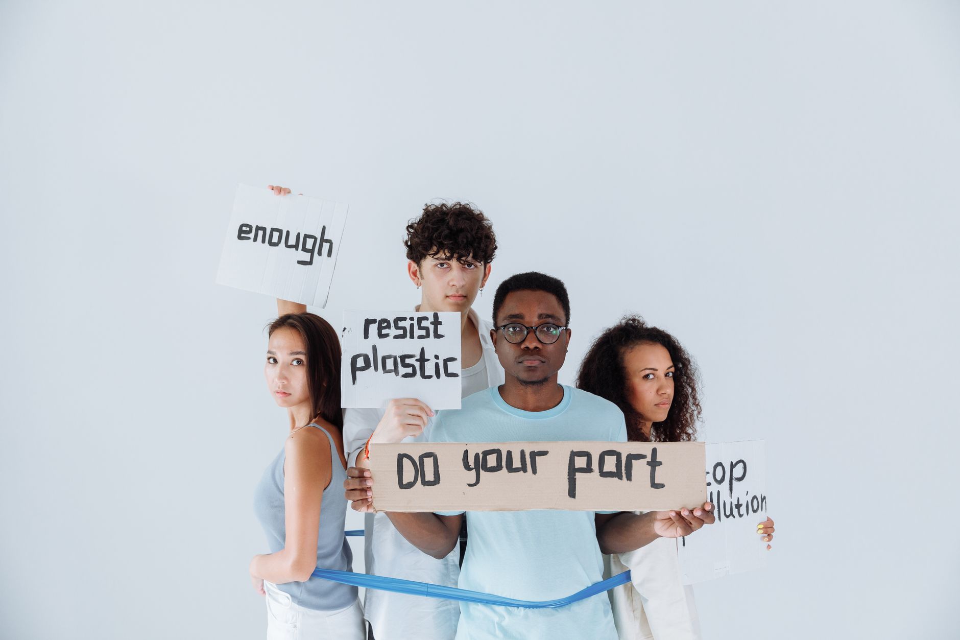 Diverse group of young activists holding signs at an environmental protest, conveying messages of change.