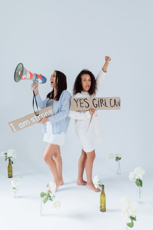 Two Women Activists Holding Placards And Megaphone