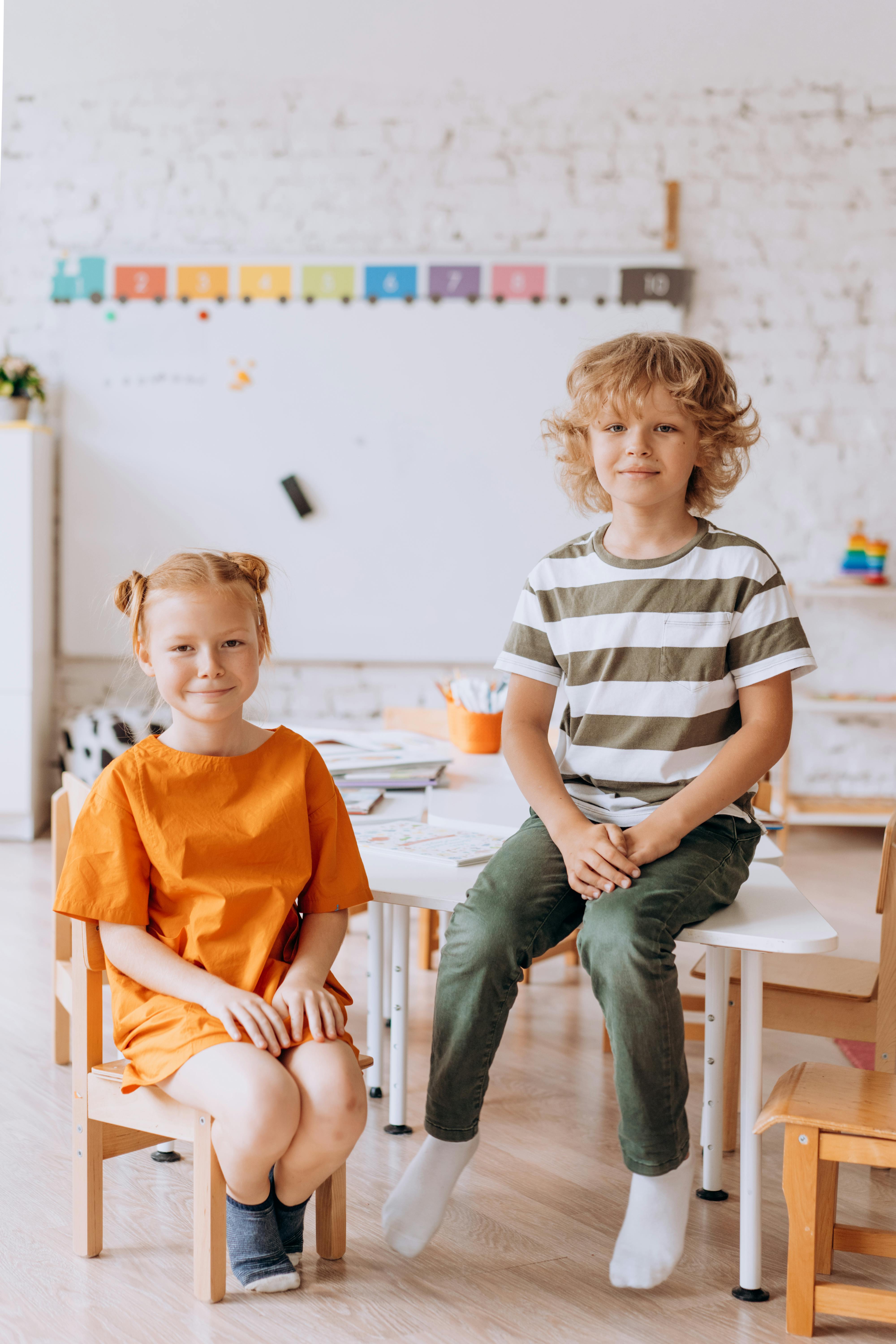 Free Vector  Boy and girl sit on the chair