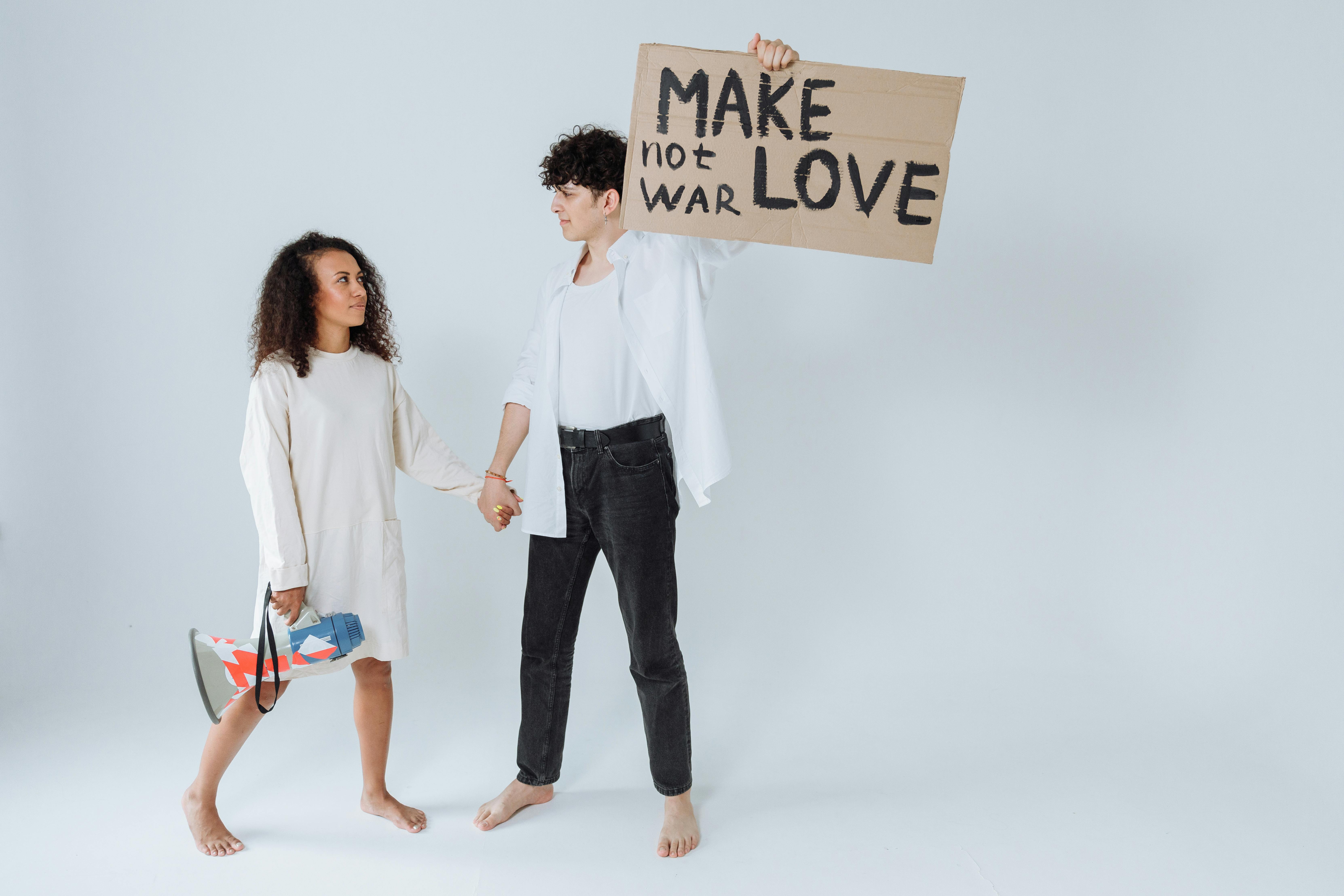 People Holding Hands While Holding a Cardboard with Message · Free Stock  Photo