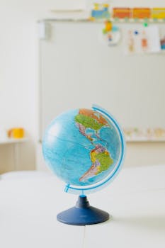 Colorful globe model placed on a classroom table, ideal for educational themes.