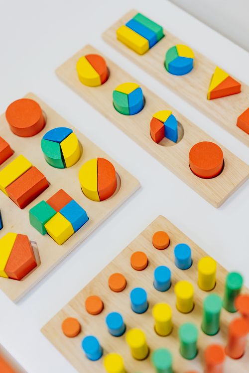 Colorful wooden shapes flashcards on desk