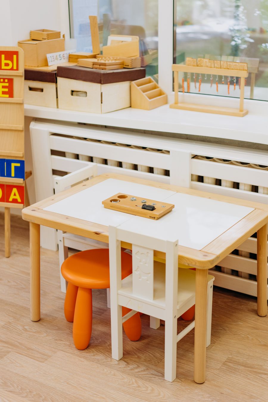 A calm, bright classroom with wooden furniture