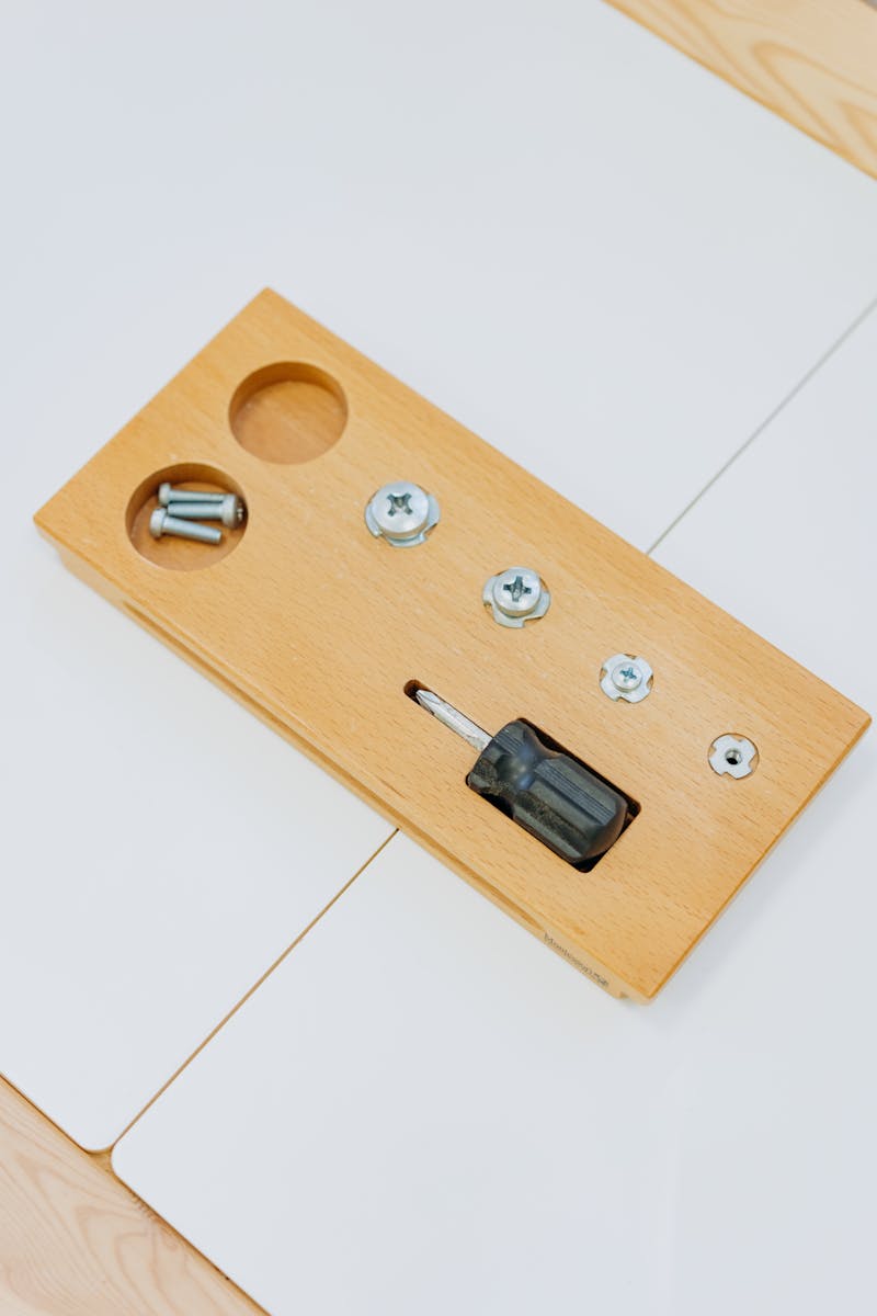 Drilling Pilot Holes – The Key to Preventing Split Wood and Stripped Screw Heads Screwdriver and wood screws on a board demonstrating pilot hole drilling for woodworking projects