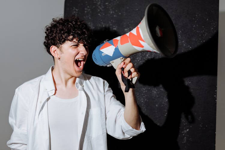 A Protester Shouting On A Megaphone