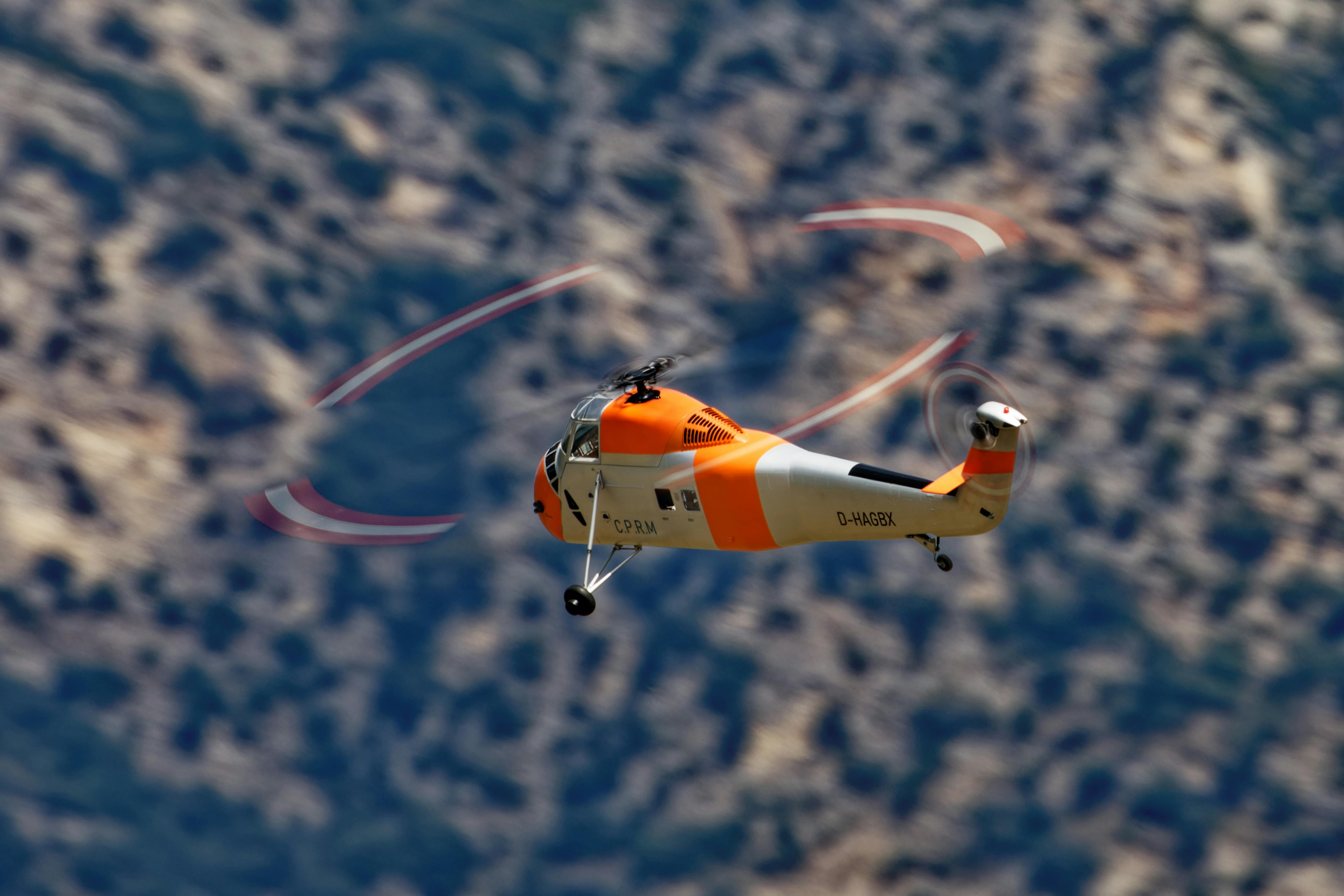Orange and White Helicopter Flying in the Sky · Free Stock Photo
