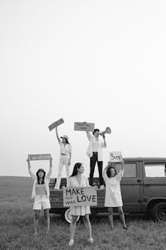 Protestors holding signs for peace in a grayscale outdoor setting.