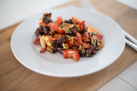 A close-up shot of colorful vegetables stir-fried on a white plate, ideal for healthy cooking.