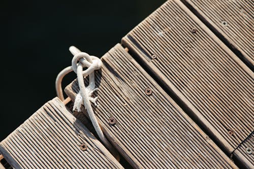 Piece of Rope Tied Between the Planks of the Pier