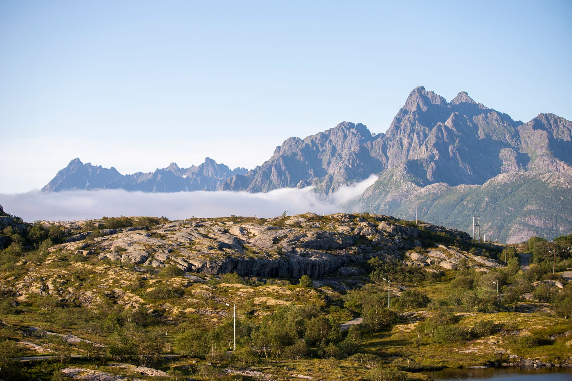 Majestic view of Norway's mountain range with lush greenery and clear skies.