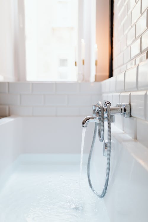 Free Photo of a Silver Faucet and a White Bathtub Stock Photo