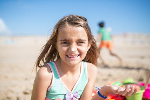 Free Young Girl in Swimwear Putting Sunscreen Stock Photo