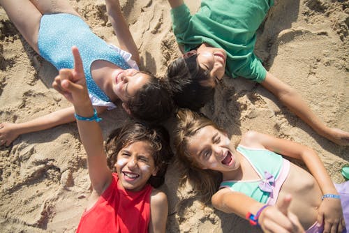 Friends Lying on the Sand