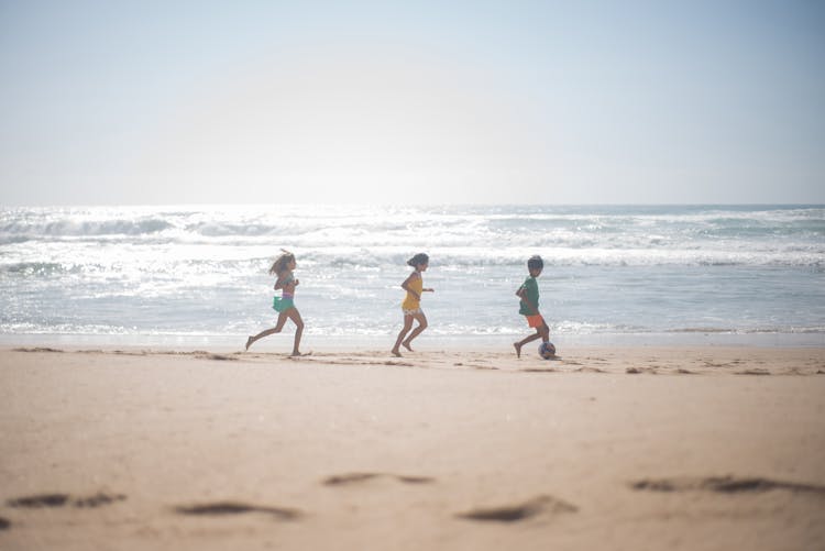 Kids Playing On The Beach