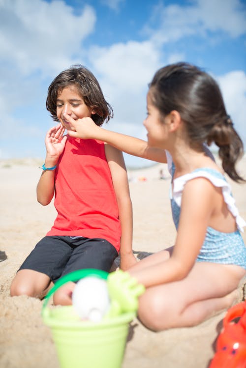 Free Kids Putting Sunblock on Their Faces Stock Photo