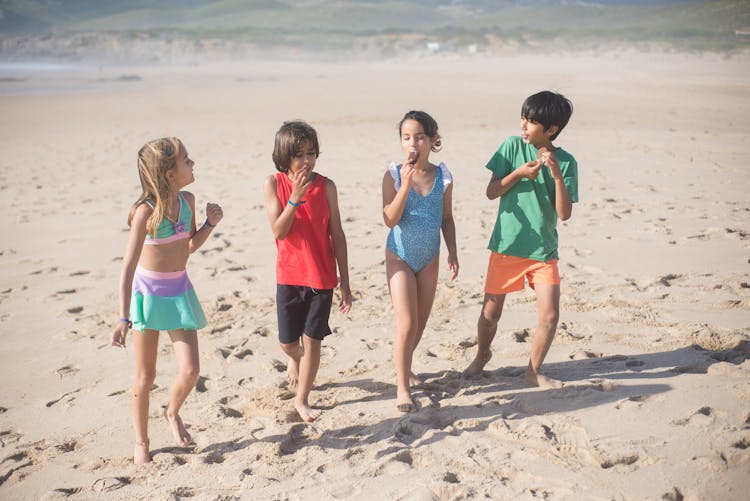 Kids Standing On The Beach