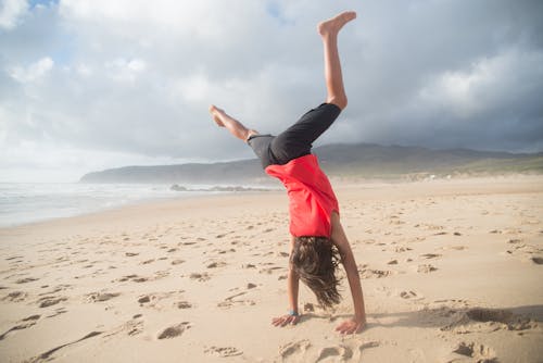 A Person Doing Handstand at the Beach