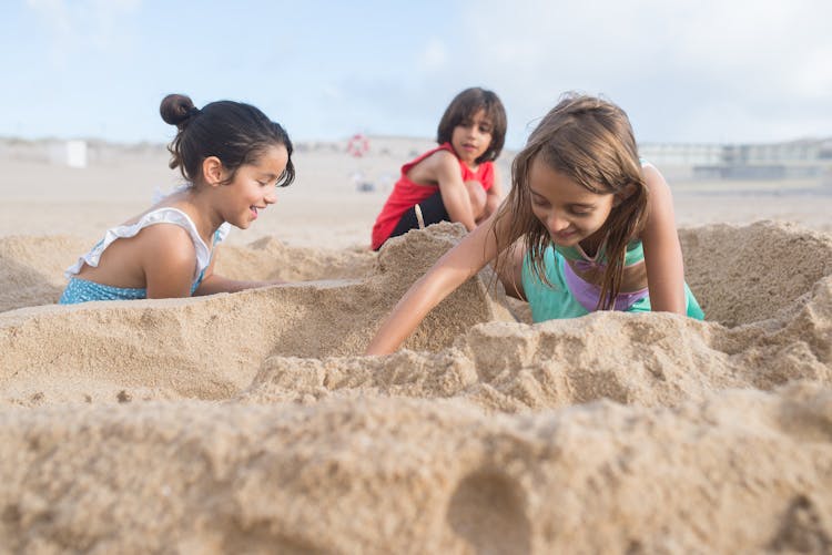 Kids Happily Playing On The Sand