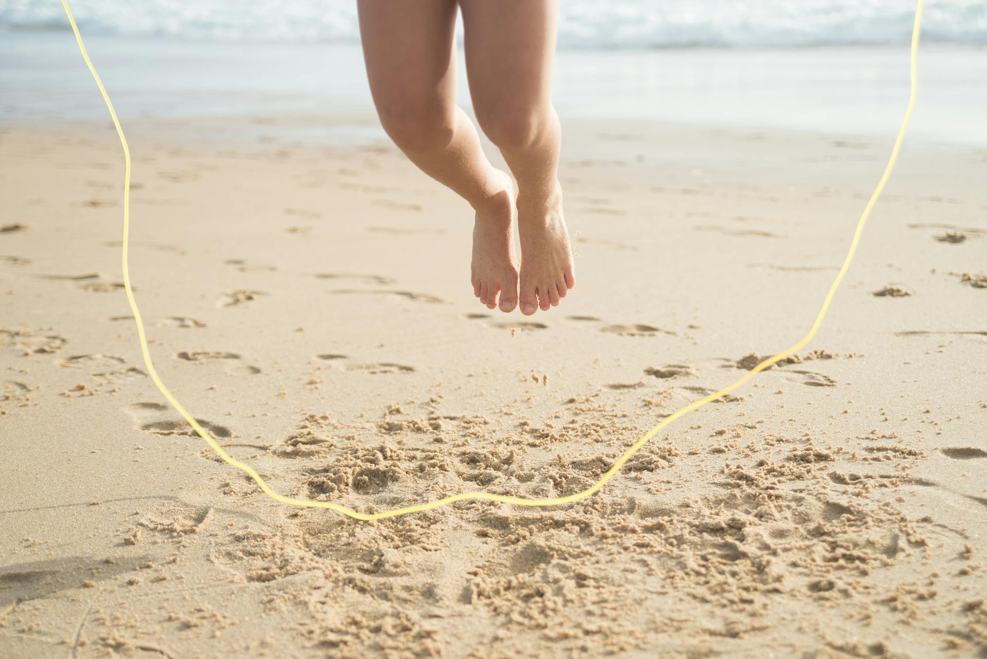 A Person Skipping Rope on a Beach