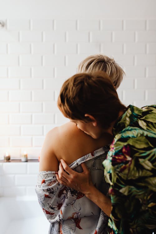 A Woman Kissing another Woman's Back