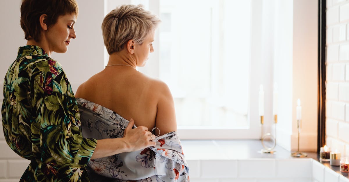 A Woman Removing another Woman's Robe · Free Stock Photo