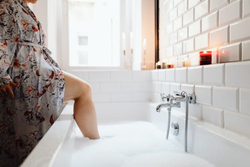 A Person Wearing a Bathrobe in the Bathtub